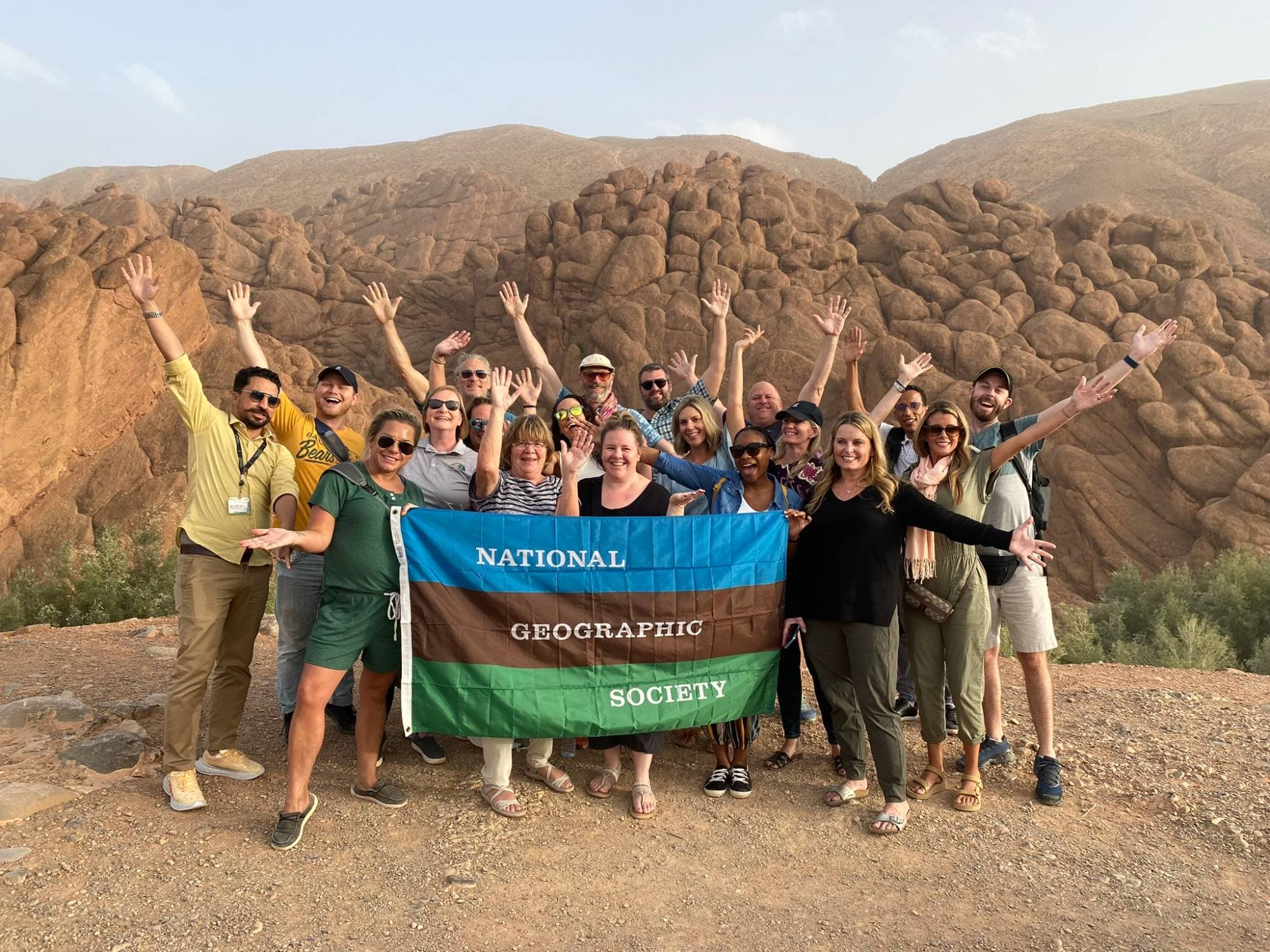 Melissa's National Geographic Expeditions group holding the National Geographic Society flag in Morocco